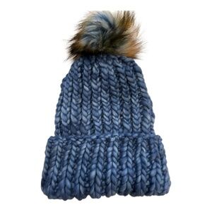 Hand knit blue variegated knit hat with faux fur pom